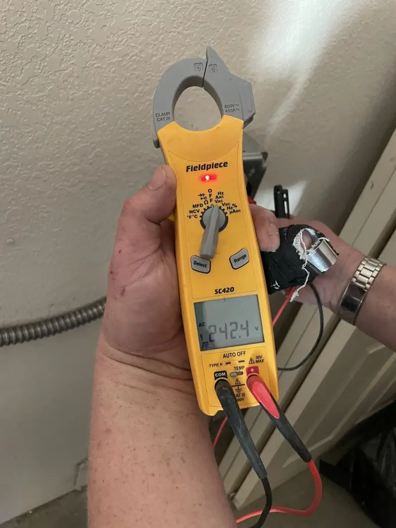 Voltage testing with clamp meter during Electrical Installation Services in Royalton